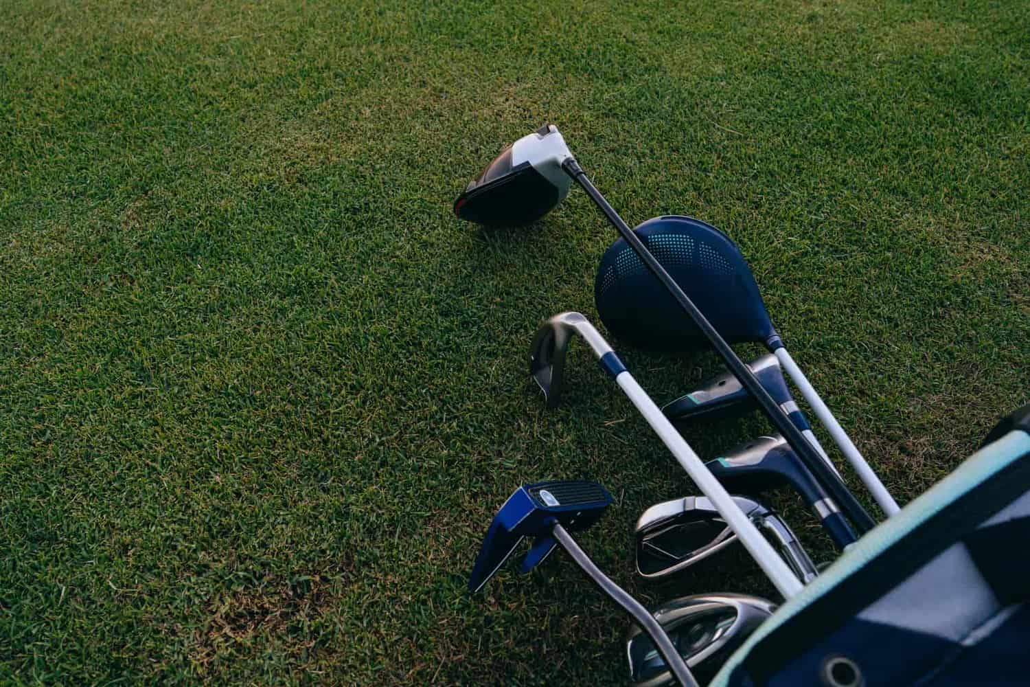 A close-up of a set of golf clubs standing in a bag